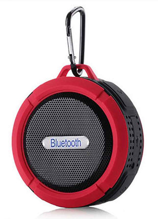 Waterproof Mini Speaker with Bluetooth, mic, and volume control in red and black design. Features a carabiner clip for portable use in wet environments.