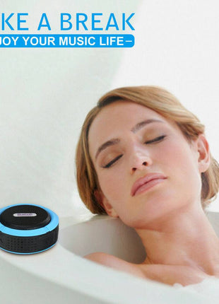 Waterproof Mini Speaker with Bluetooth and mic resting on bathtub edge as woman relaxes, ideal for shower music enjoyment and hands-free calls.